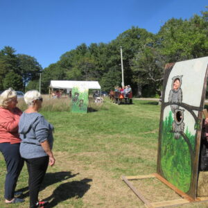 Children posing for pictures at photo stand-ins at Prescott Farm Environmental Education Center Harvest Festival 2022 