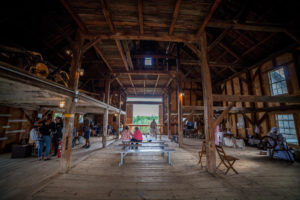 Prescott Farm Environmental Education Center inside barn with colonial reenactors for Harvest Festival 